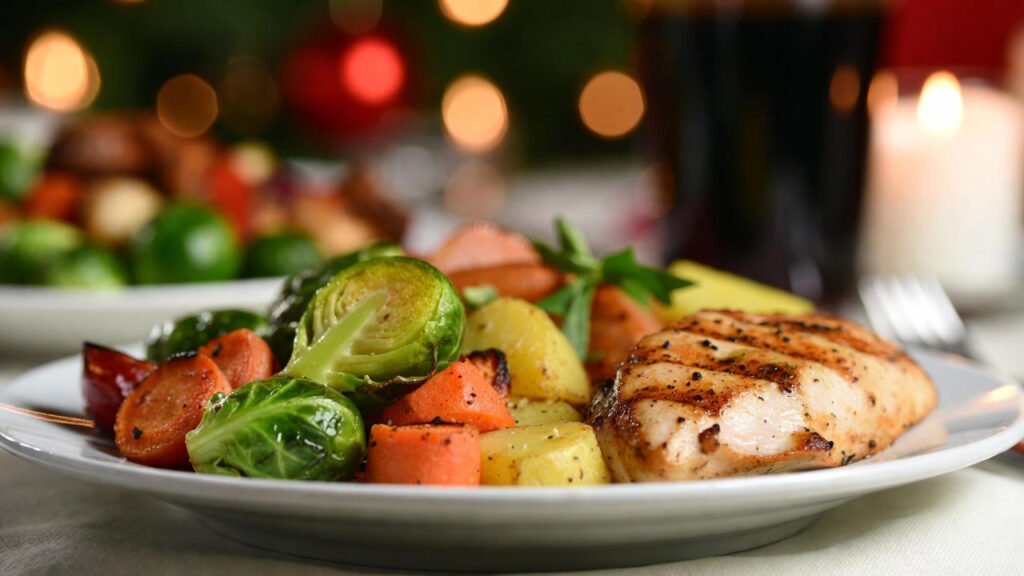 Festive dinner plate with vegetables, lean protein, and winter sides, warm lighting, cozy holiday setting.